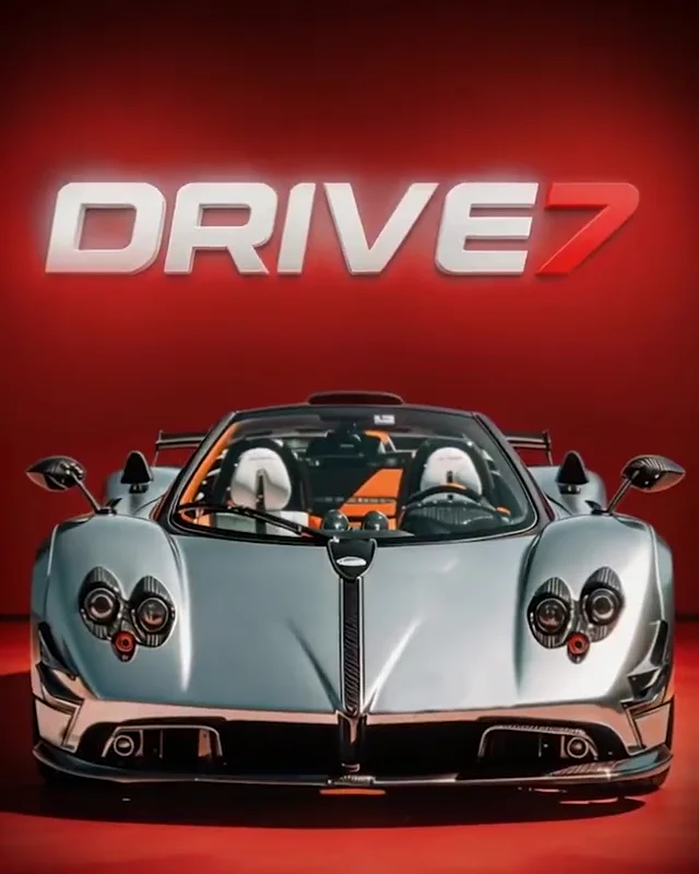 A polished silver classic Porsche in front of the DRIVE7 sign